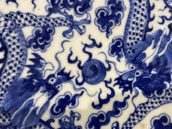 A Chinese blue and white 'dragon' dish and a famille rose figure of Buddha, 19th C.