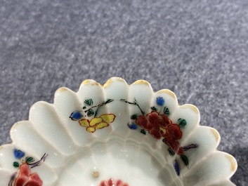 A Chinese famille rose cup and saucer and a 'magnolia' cup, Yongzheng