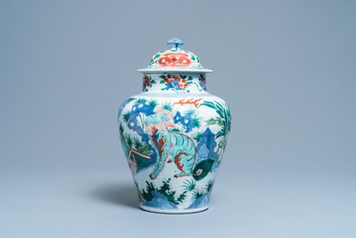 A Chinese wucai 'mythical beasts' vase and cover, Transitional period