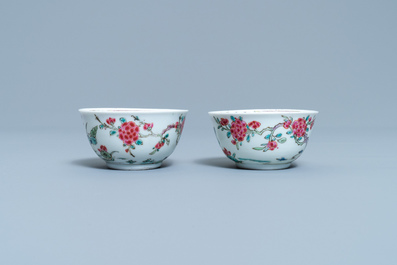 A pair of Chinese famille rose 'mountainous landscape' cups and saucers, Yongzheng