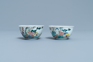 A pair of Chinese famille rose 'mountainous landscape' cups and saucers, Yongzheng