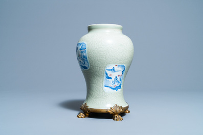 Un vase en porcelaine de Chine c&eacute;ladon monochrome &agrave; d&eacute;cor incis&eacute; et aux panneaux en bleu, blanc et rouge de cuivre, Kangxi