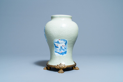 Un vase en porcelaine de Chine c&eacute;ladon monochrome &agrave; d&eacute;cor incis&eacute; et aux panneaux en bleu, blanc et rouge de cuivre, Kangxi