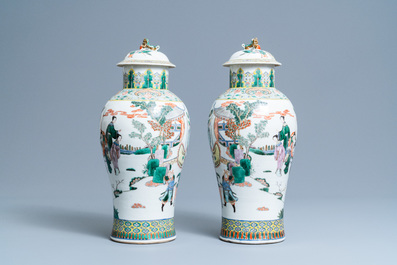 A pair of Chinese famille verte vases and covers with warrior scenes, 19th C.