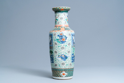 A Chinese famille verte rouleau vase with ladies in a garden, 19th C.