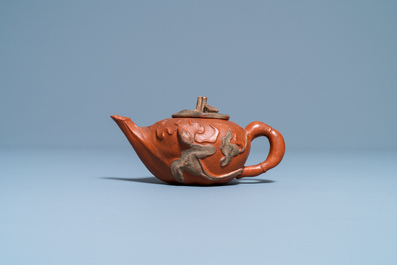 A Chinese relief-decorated Yixing stoneware teapot and cover, 18/19th C.