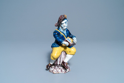 A polychrome Dutch Delft figure of a hurdy-gurdy player, 18th C.