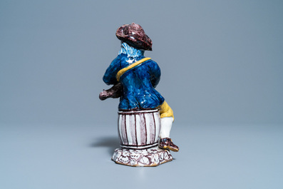 A polychrome Dutch Delft figure of a hurdy-gurdy player, 18th C.
