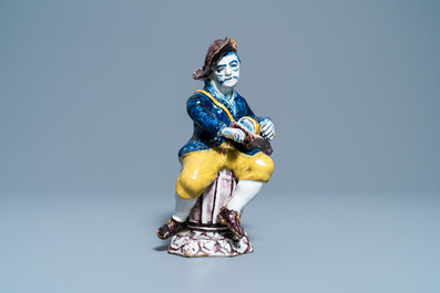 A polychrome Dutch Delft figure of a hurdy-gurdy player, 18th C.