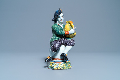 A polychrome Dutch Delft figure of a bagpipe player, 18th C.