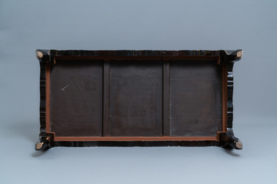 A Chinese rectangular lacquered wood table for the European market, 19th C.