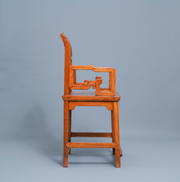 A Chinese wooden chair with inserted carved panels, 19th C.
