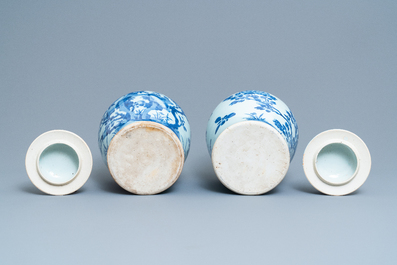 A pair of Chinese blue and white baluster vases and covers with birds in a rocky landscape, Kangxi