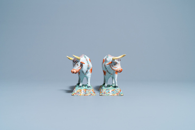 A pair of polychrome petit feu and gilded Dutch Delft models of cows, 1st half 18th C.