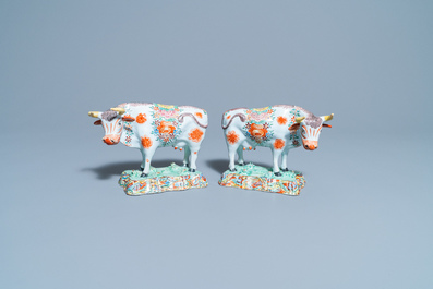 A pair of polychrome petit feu and gilded Dutch Delft models of cows, 1st half 18th C.