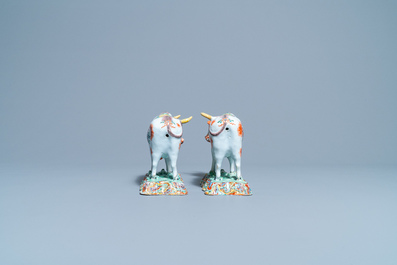 A pair of polychrome petit feu and gilded Dutch Delft models of cows, 1st half 18th C.