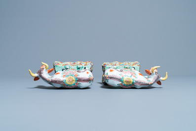 A pair of polychrome petit feu and gilded Dutch Delft models of cows, 1st half 18th C.