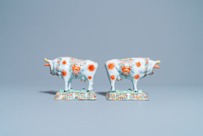 A pair of polychrome petit feu and gilded Dutch Delft models of cows, 1st half 18th C.