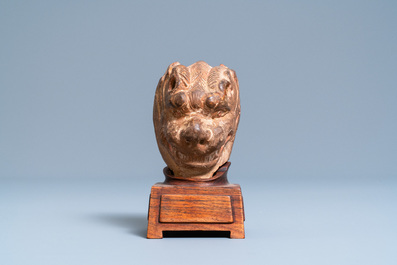 A Chinese painted pottery model of a mythical beast's head, Tang