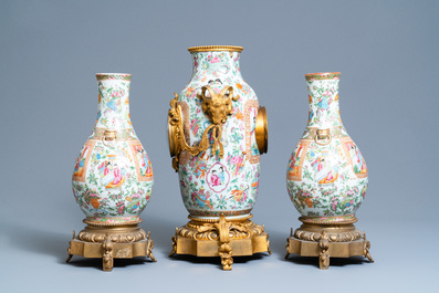 A Chinese gilt bronze-mounted three-piece Canton famille rose clock garniture, 19th C.