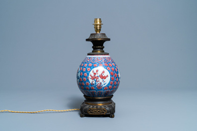A Chinese blue, white and copper red gilt bronze lamp-mounted vase, 19th C.