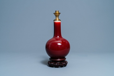 A Chinese monochrome sang de boeuf lamp-mounted bottle vase, 19/20th C.