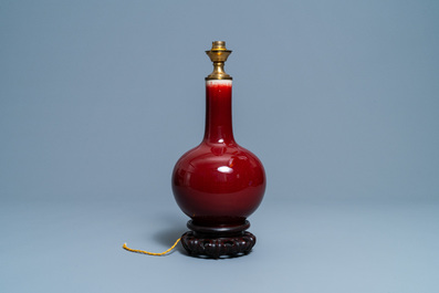 A Chinese monochrome sang de boeuf lamp-mounted bottle vase, 19/20th C.