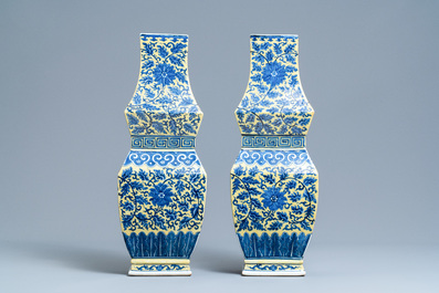 A pair of Chinese blue and white yellow-ground vases, 19th C.