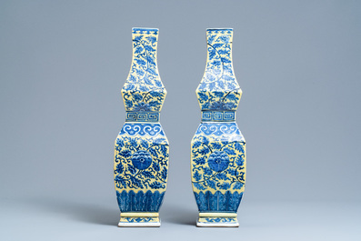 A pair of Chinese blue and white yellow-ground vases, 19th C.