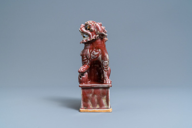 A Chinese monochrome sang de boeuf model of a Buddhist lion, 19th C.
