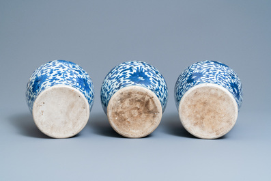 Three Chinese blue and white 'lotus scroll' vases and covers, Transitional period/Kangxi