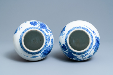 A pair of Chinese blue and white vases and covers with figures in a landscape, 19th C.