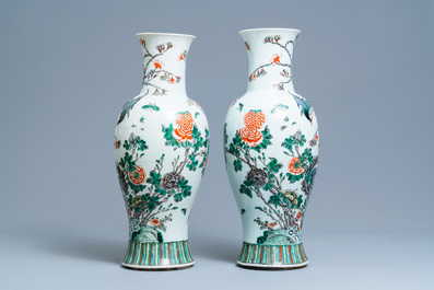 A pair of Chinese famille verte vases with birds among blossoming branches, 19th C.