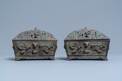 A pair of Chinese Ming-style bronze censers with reticulated covers, 19th C.