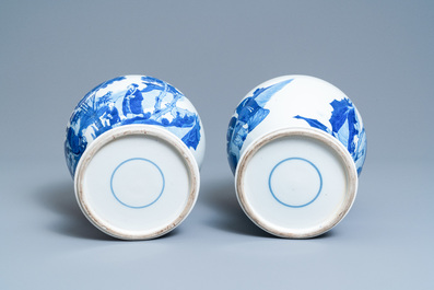 A pair of Chinese blue and white vases and covers with figures in a landscape, 19th C.