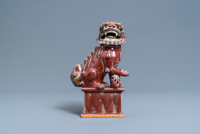 A Chinese monochrome sang de boeuf model of a Buddhist lion, 19th C.