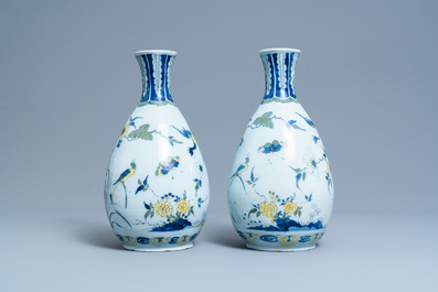 A pair of unusual polychrome Dutch Delft chinoiserie vases with a dragon and birds in a flowery garden, 17th C.