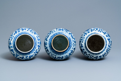 Three Chinese blue and white 'lotus scroll' vases and covers, Transitional period/Kangxi