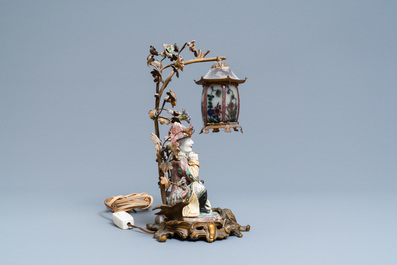 A Chinese famille verte figure mounted into a lamp with gilt bronze, glass and Samson porcelain, 19th C.
