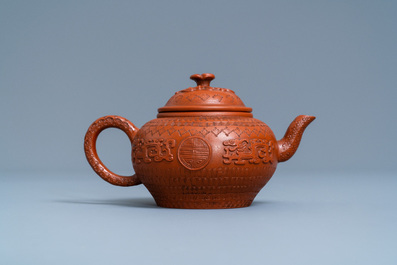 A Chinese Yixing stoneware teapot and cover with applied and impressed design, Kangxi