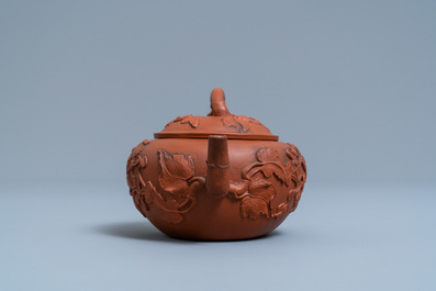 A Chinese Yixing stoneware teapot and cover with applied floral design, Kangxi