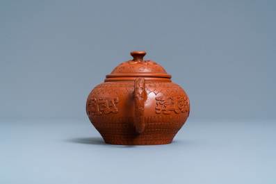 A Chinese Yixing stoneware teapot and cover with applied and impressed design, Kangxi