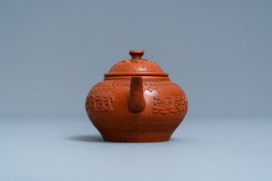 A Chinese Yixing stoneware teapot and cover with applied and impressed design, Kangxi