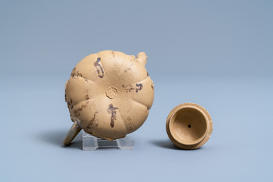 A bichrome Chinese Yixing stoneware teapot and cover with applied floral design, 19th C.