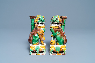 A pair of Chinese sancai-glazed biscuit Buddhist lion joss stick holders, Kangxi