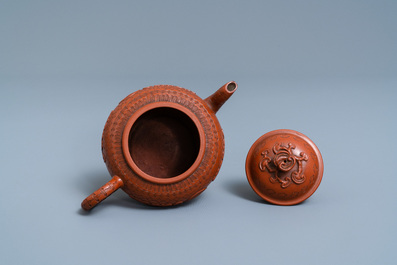 A Chinese Yixing stoneware teapot and cover with applied and impressed design, Kangxi