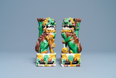 A pair of Chinese sancai-glazed biscuit Buddhist lion joss stick holders, Kangxi