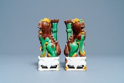 A pair of Chinese sancai-glazed biscuit Buddhist lion joss stick holders, Kangxi