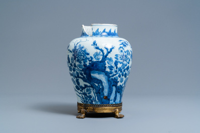 A Chinese blue and white vase on a gilt bronze foot, Kangxi