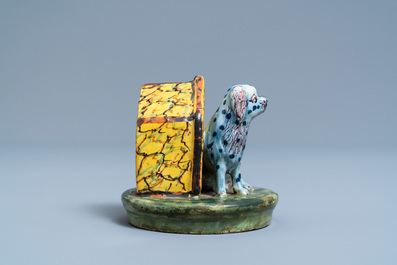 A polychrome Dutch Delft model of a dog by its doghouse, 18th C.